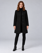 Woman wearing black tailored longline wool-blend coat with button front and side pockets, front view