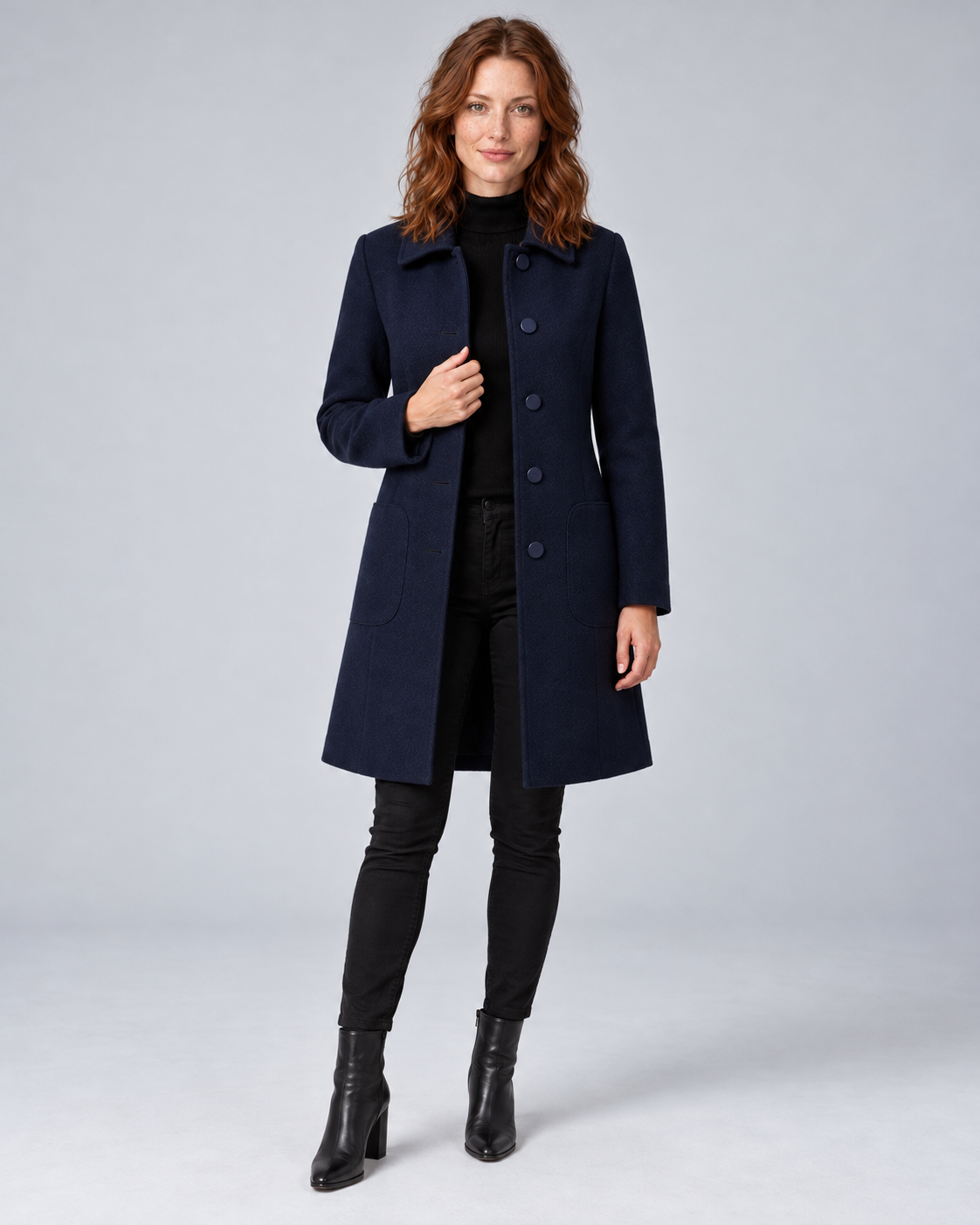 Woman wearing navy tailored longline wool-blend coat with button front and side pockets, front view