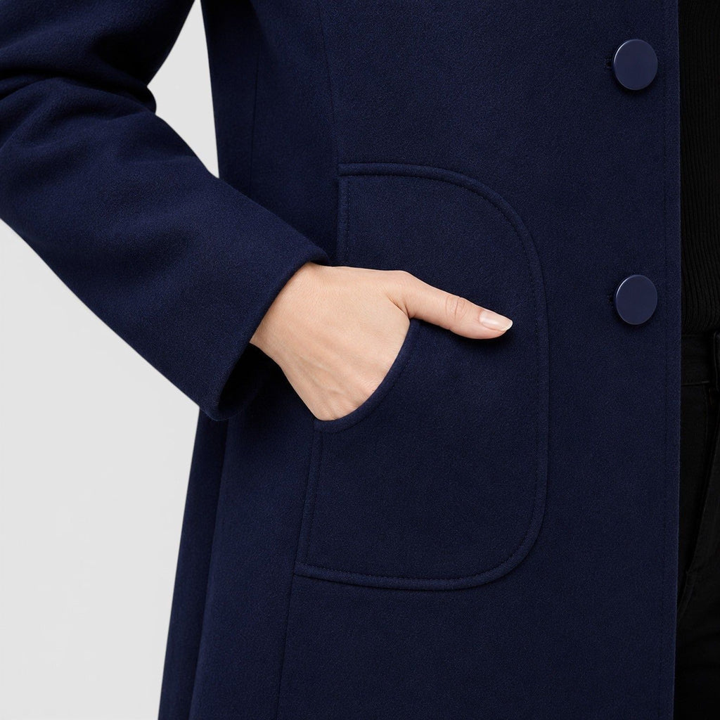 Original navy coat detail showing curved patch pocket opening, tonal buttons and wool-blend fabric texture