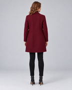 Woman wearing wine tailored longline wool-blend coat with button front and side pockets, rear view
