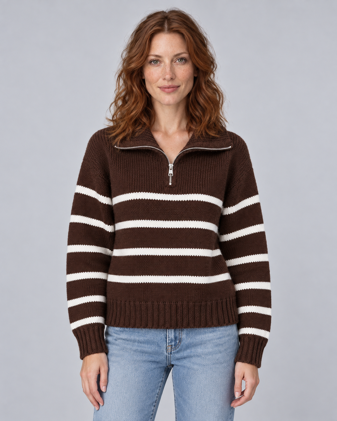 Woman wearing brown striped half-zip funnel-neck jumper with long raglan sleeves, front view