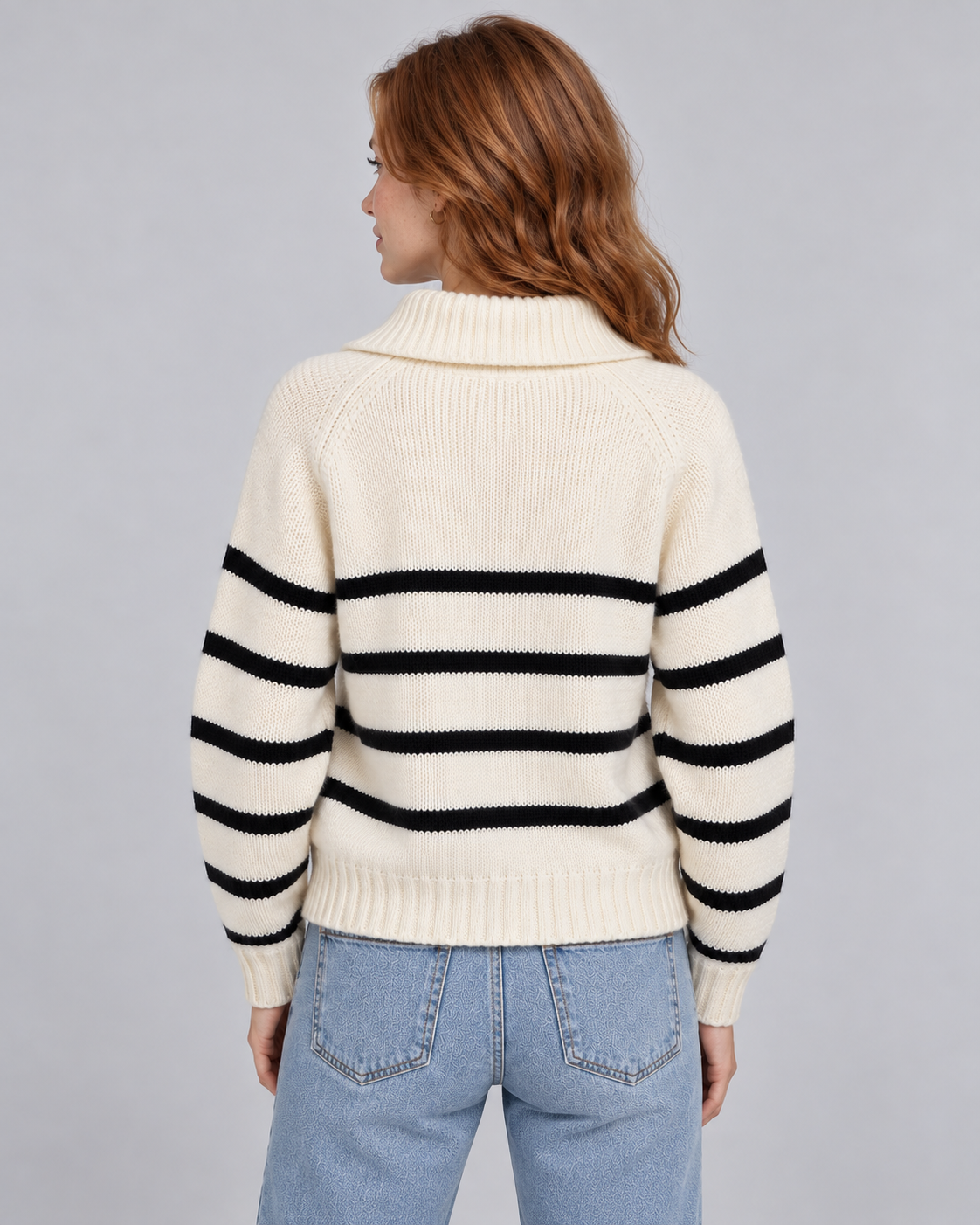 Woman wearing white striped half-zip funnel-neck jumper with long raglan sleeves, rear view