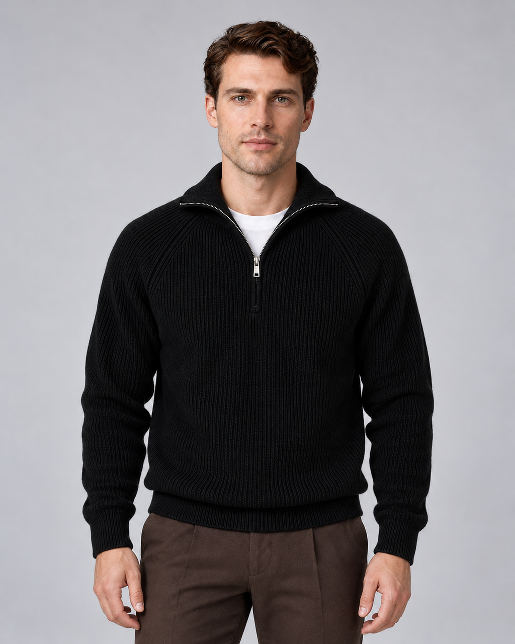 Man wearing black quarter-zip ribbed knitted sweater with stand collar, front view