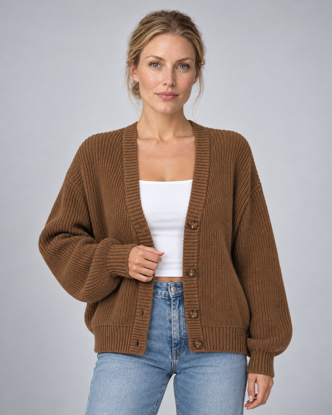 Woman wearing brown V-neck ribbed button-front cardigan with long sleeves, front view