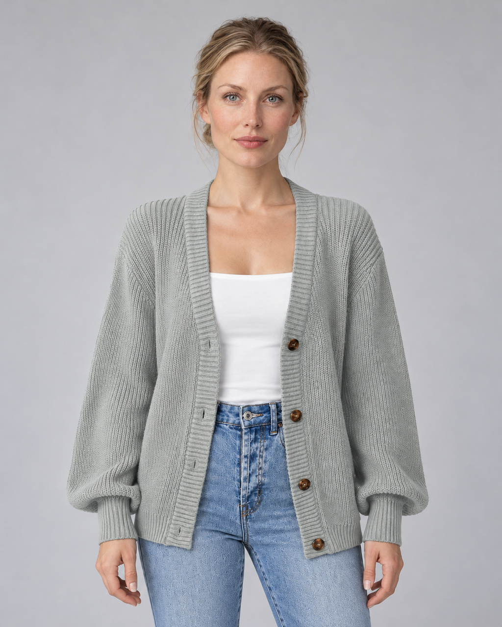 Woman wearing grey V-neck ribbed button-front cardigan with long sleeves, front view