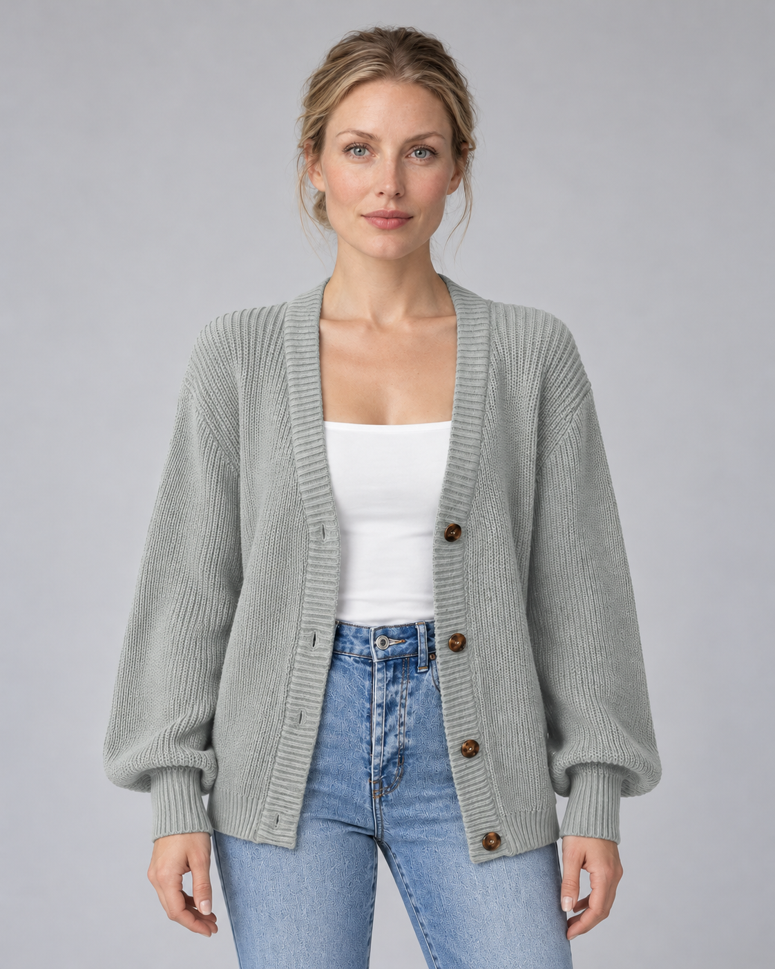 Woman wearing grey V-neck ribbed button-front cardigan with long sleeves, front view