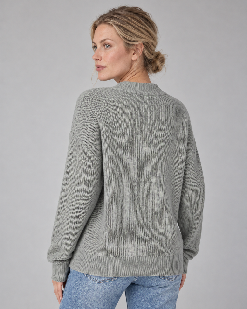 Woman wearing grey V-neck ribbed button-front cardigan with long sleeves, rear view