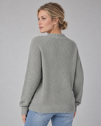 Woman wearing grey V-neck ribbed button-front cardigan with long sleeves, rear view