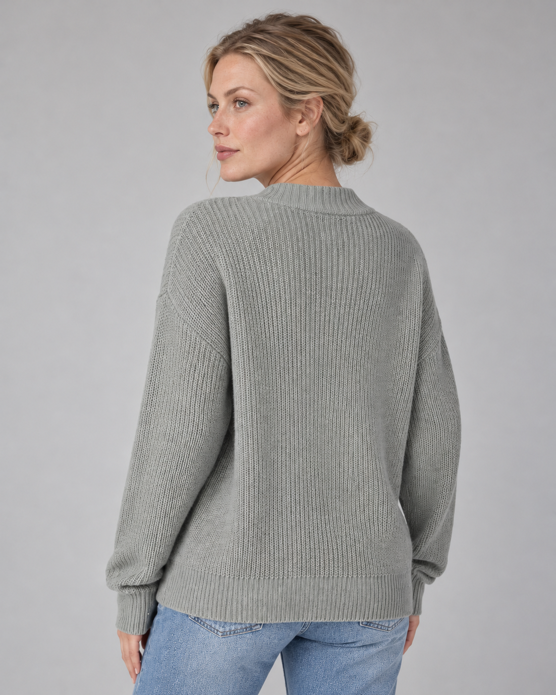 Woman wearing grey V-neck ribbed button-front cardigan with long sleeves, rear view