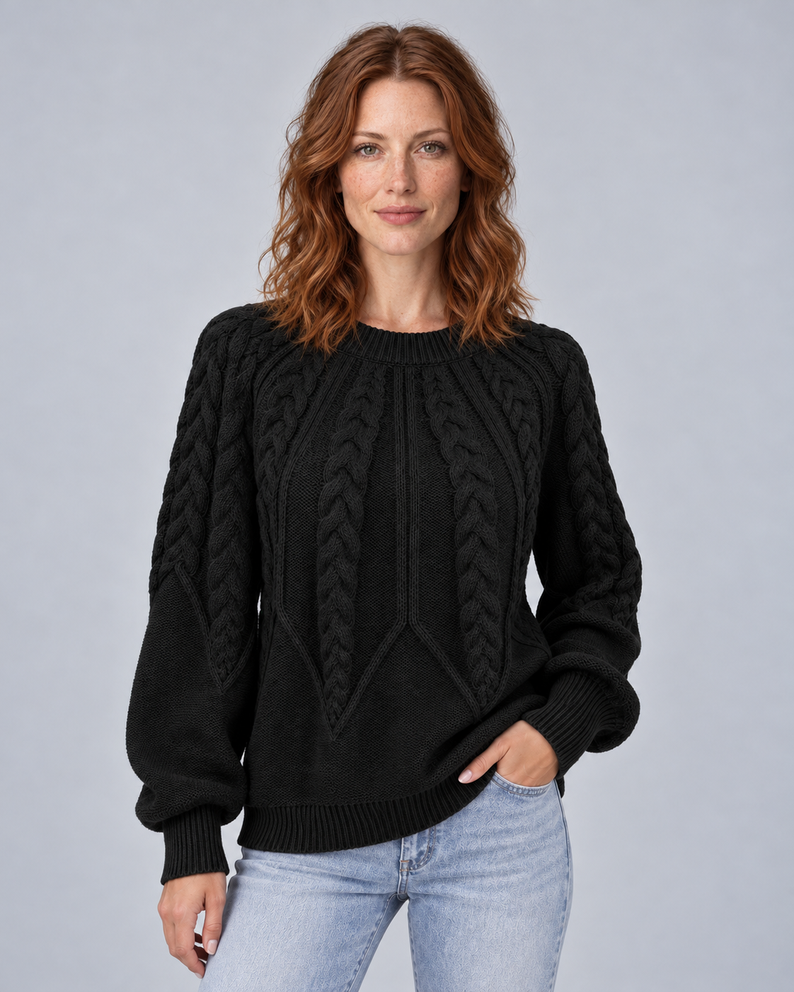 Woman wearing black cable knit crew neck jumper, front view